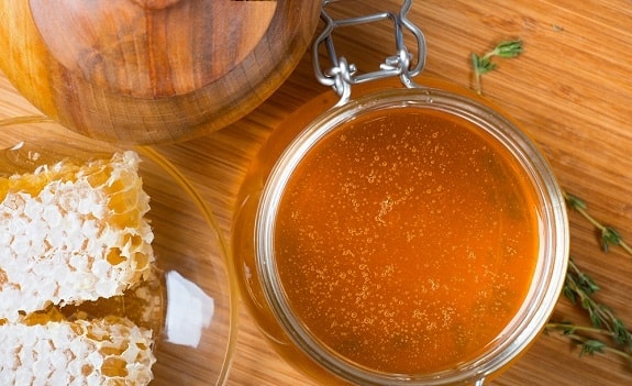 Harvested Honey in Jar and Honeycomb